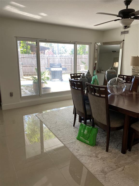 7230 Shepherd Street Sarasota, FL 34243 - Photo 5 of 38 a view of a dining room with furniture and a window