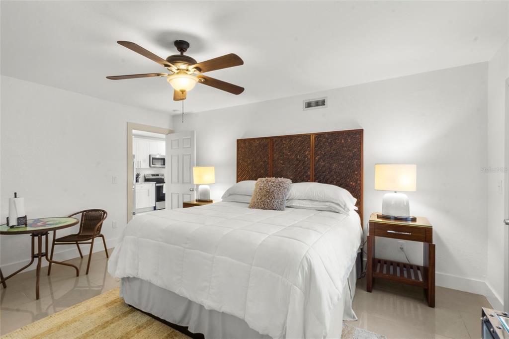 7230 Shepherd Street Sarasota, FL 34243 - Photo 6 of 30 a bedroom with a bed and a chandelier