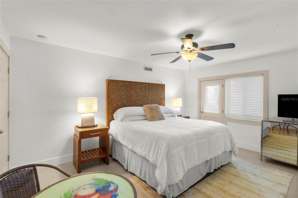 7230 Shepherd Street Sarasota, FL 34243 - Photo 7 of 30 a bedroom with a bed and a chandelier