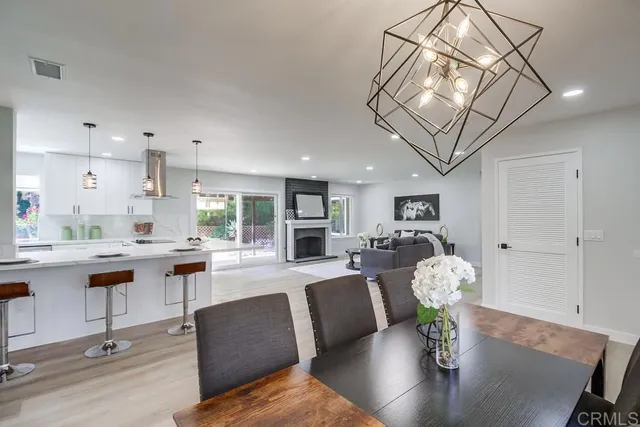 a large kitchen with granite countertop a large counter top a sink stainless steel appliances and cabinets