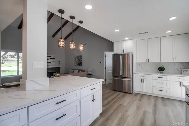 a view of washer and dryer with bathroom in the background