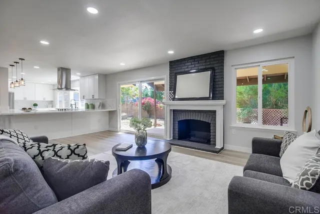 a kitchen with a sink stainless steel appliances cabinets and a large window