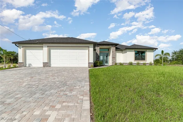 a front view of house with yard and green space