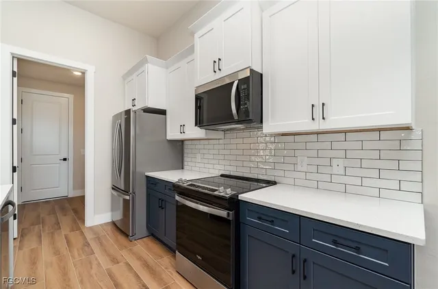 a kitchen with stainless steel appliances a refrigerator sink and microwave