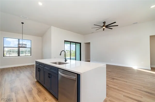 a kitchen with a sink appliances and a window