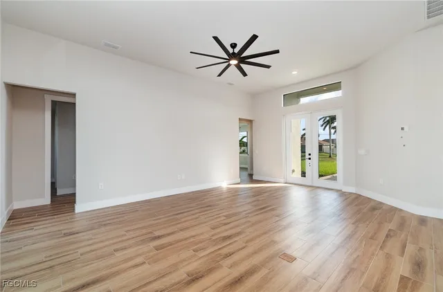 a view of empty room with wooden floor