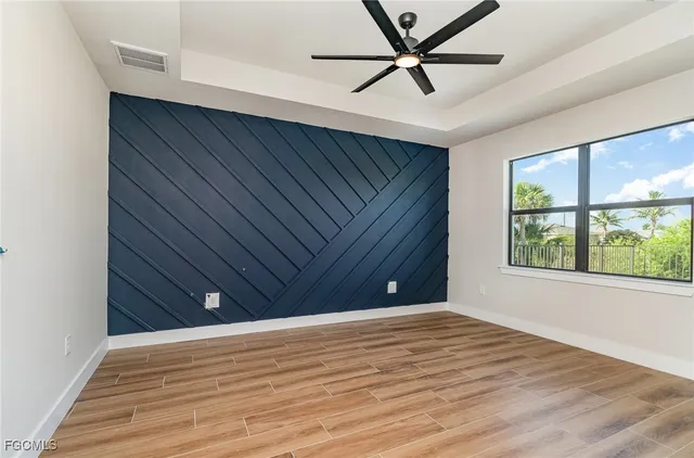 a view of a livingroom with a ceiling fan and wooden floor