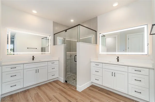 a bathroom with a granite countertop sink mirror and a toilet