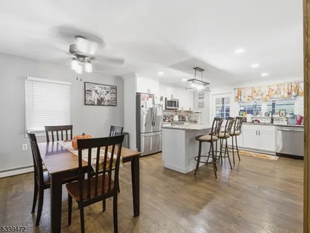 a view of a dining room with furniture and wooden floor