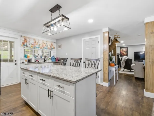a kitchen with center island and wooden floor