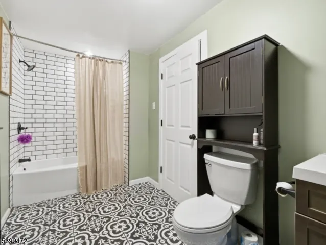 a bathroom with a toilet a sink and shower