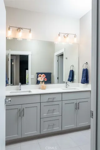 a spacious bathroom with a sink and mirror