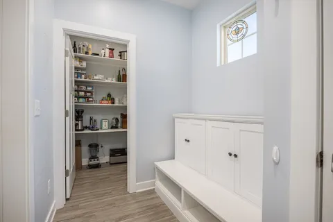 a bedroom with a bed and a flat tv screen on dresser