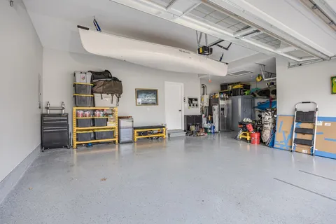 a kitchen with white cabinets a sink a stove and a refrigerator