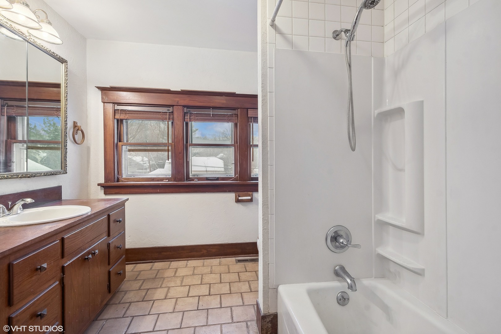 32 East Maple Avenue Roselle, IL 60172 - Photo 13 of 19 a bathroom with a bathtub sink vanity and mirror