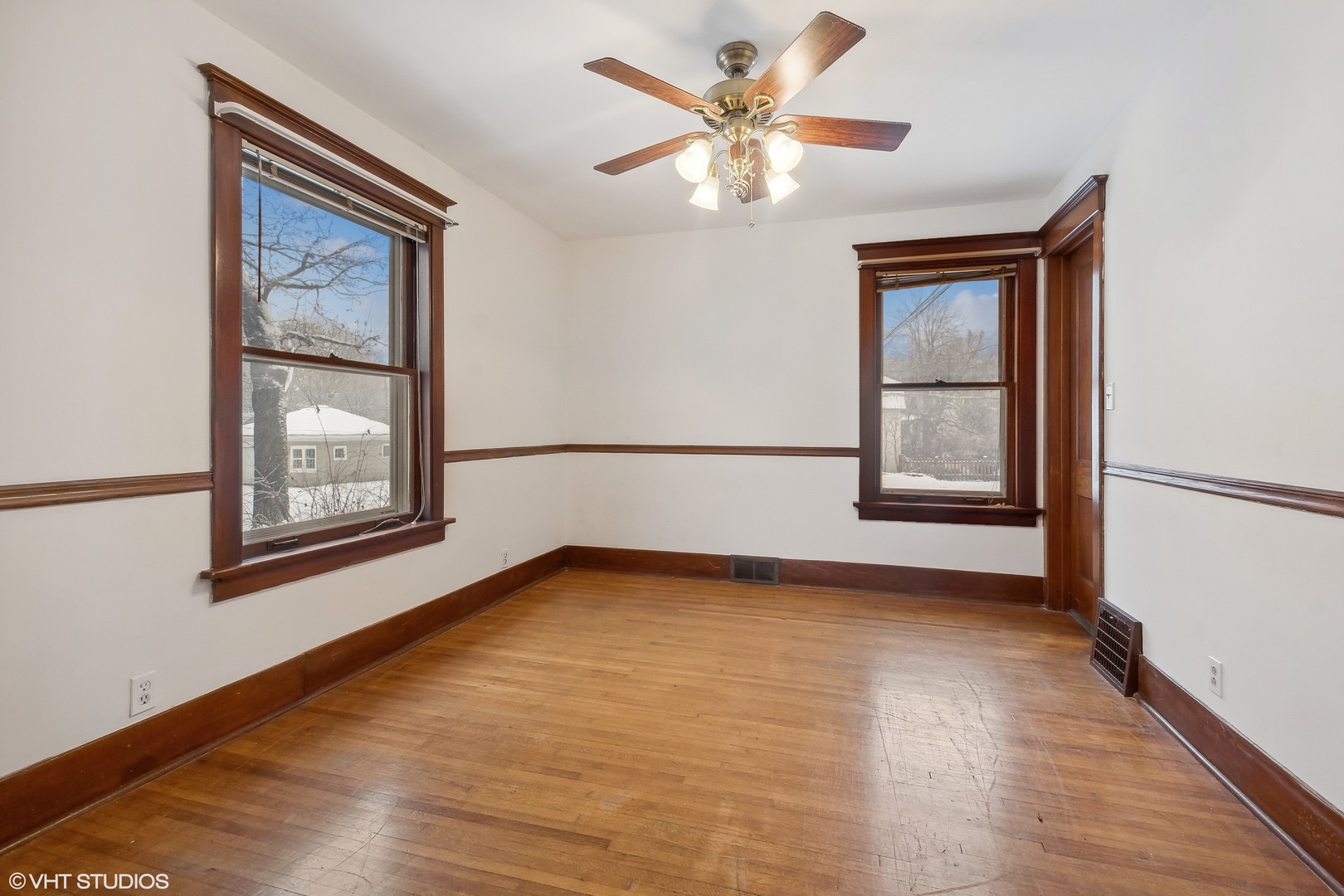32 East Maple Avenue Roselle, IL 60172 - Photo 9 of 19 a view of an empty room with chandelier fan and wooden floor