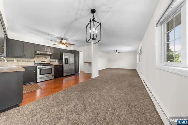 a view of a kitchen with a sink and stainless steel appliances