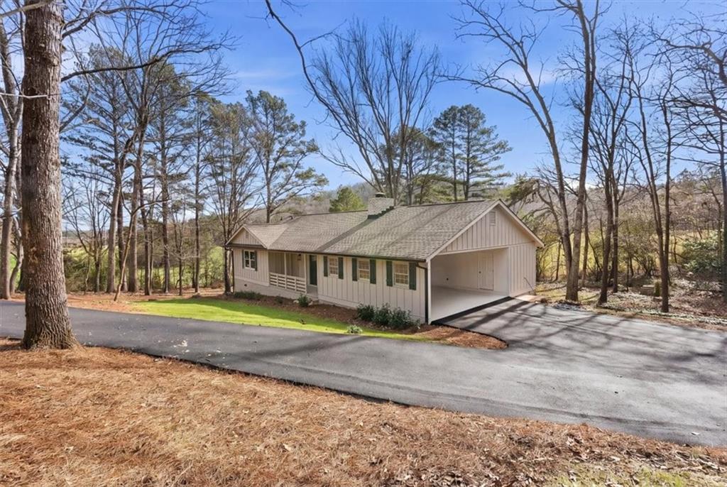 49 Apache Trail Cartersville, GA 30120 - Photo 2 of 52 a view of large house with a big yard and large trees