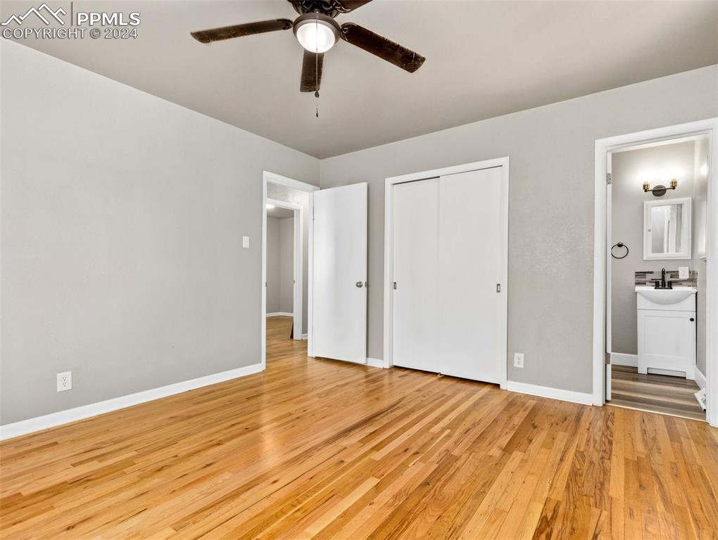 65 University Circle Pueblo, CO 81005 - Photo 16 of 32 an empty room with wooden floor and a ceiling fan