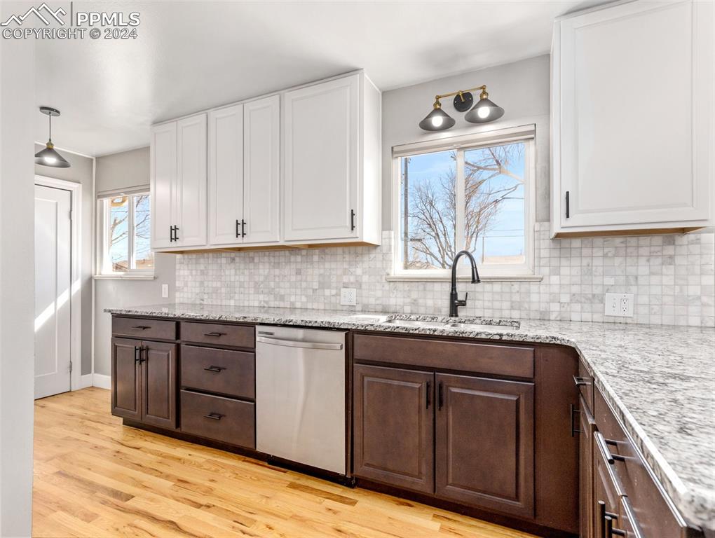 65 University Circle Pueblo, CO 81005 - Photo 5 of 32 a kitchen with granite countertop a sink and cabinets