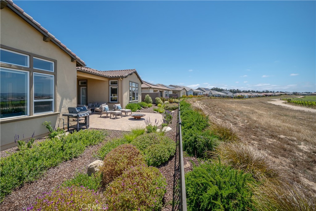 1630 Eucalyptus Road Nipomo, CA 93444 - Photo 22 of 75 a front view of a house with lake view and a garden
