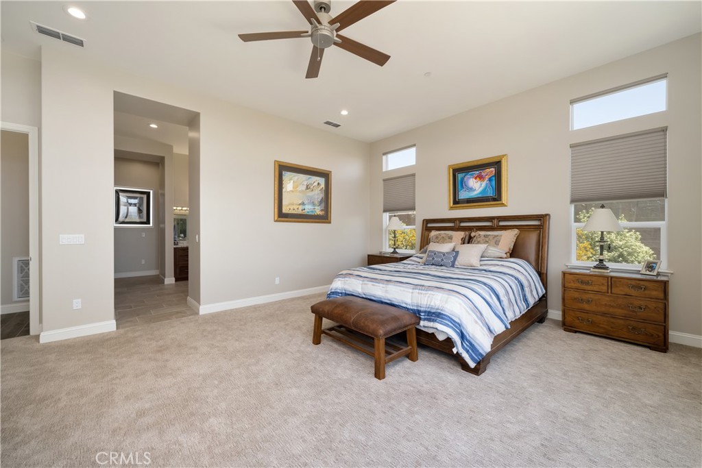 1630 Eucalyptus Road Nipomo, CA 93444 - Photo 31 of 75 a bedroom with a bed and a chandelier