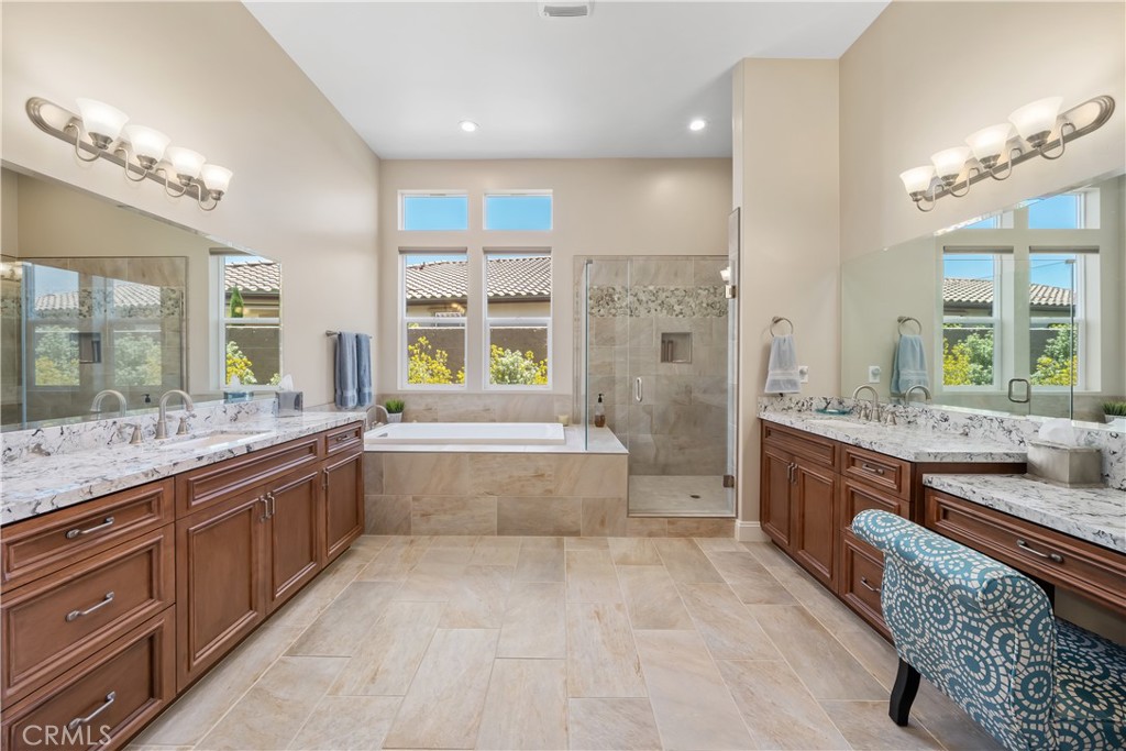 1630 Eucalyptus Road Nipomo, CA 93444 - Photo 32 of 75 a large bathroom with a granite countertop tub a double vanity sink a large mirror and a bathtub