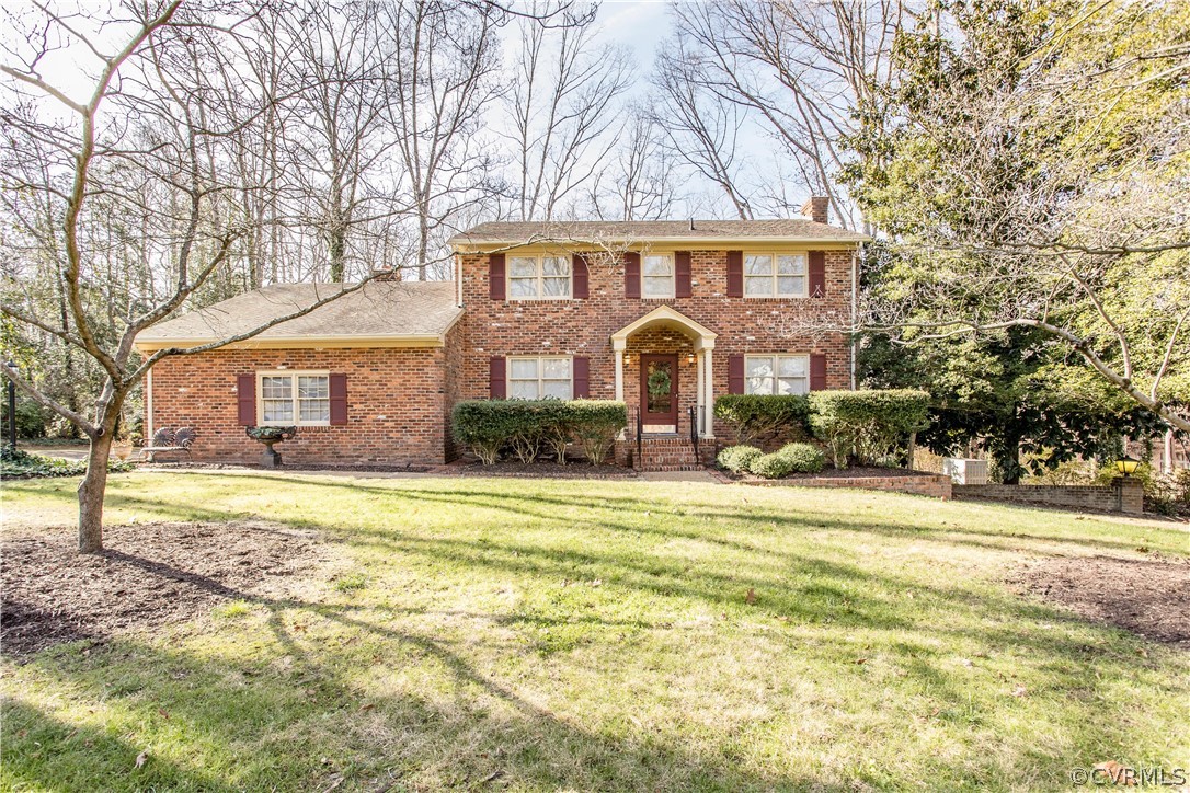 12912 Silver Crest Road Chester, VA 23831 - Photo 1 of 45 a front view of a house with a yard and garage
