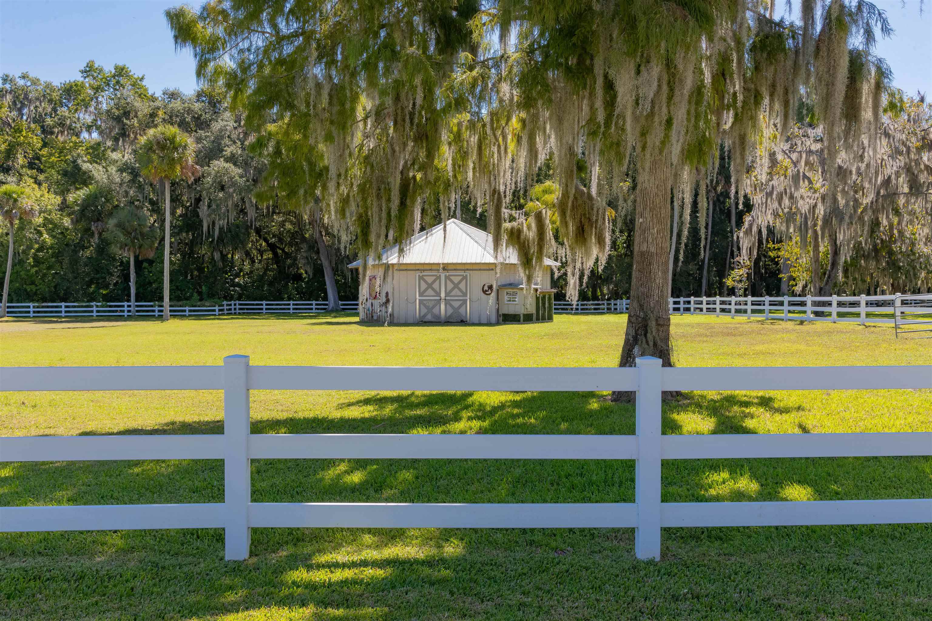 141 Wooten Rd Crescent Crescent City, FL 32112 - Photo 14 of 72 a view of swimming pool with lawn chairs and a big yard