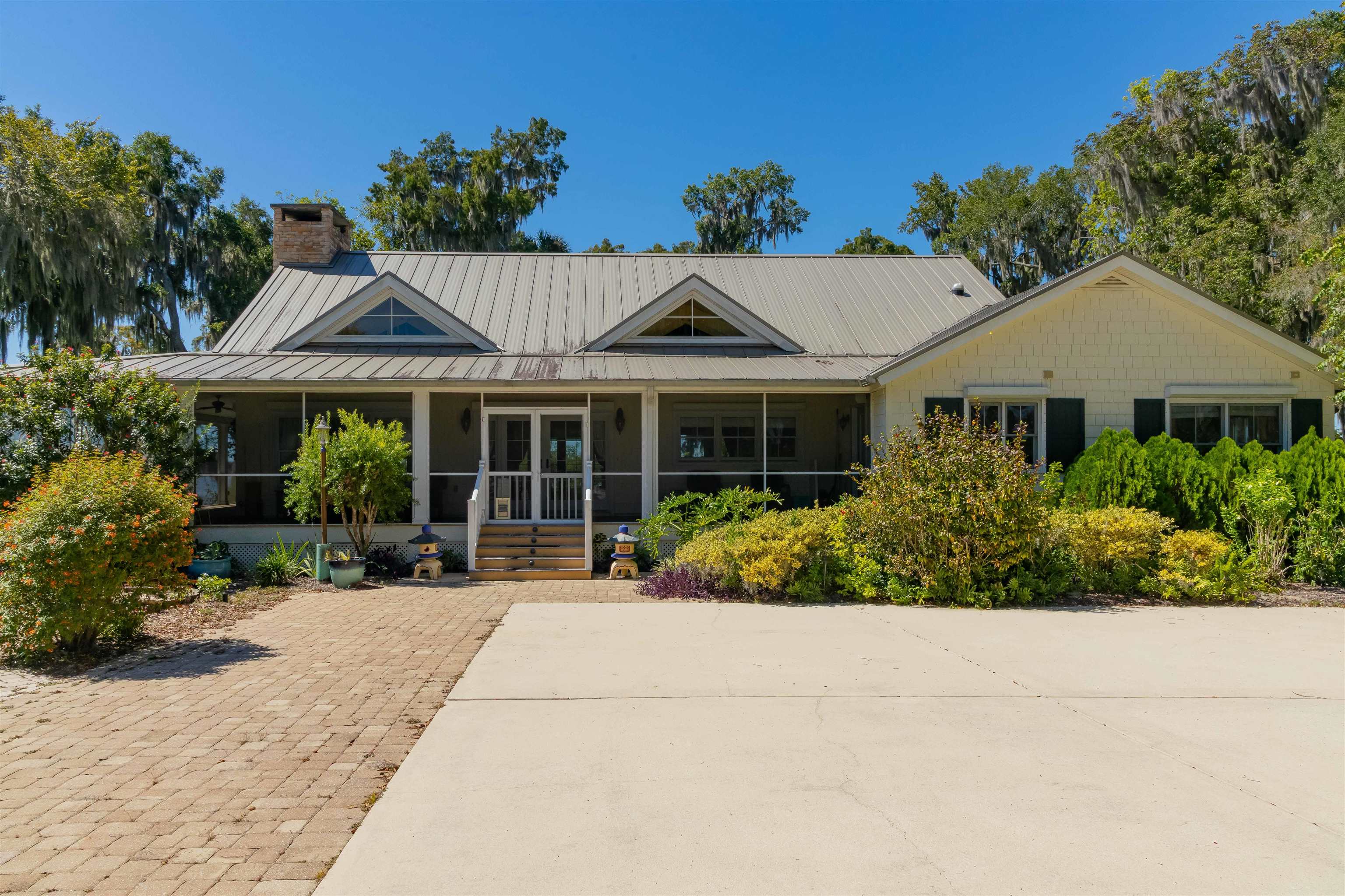 141 Wooten Rd Crescent Crescent City, FL 32112 - Photo 2 of 72 a front view of a house with a garden