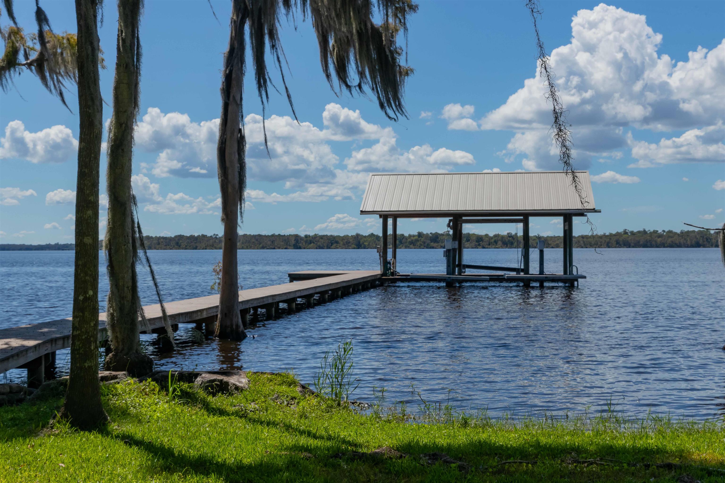 141 Wooten Rd Crescent Crescent City, FL 32112 - Photo 29 of 72 a view of a swimming pool with a yard and sitting area