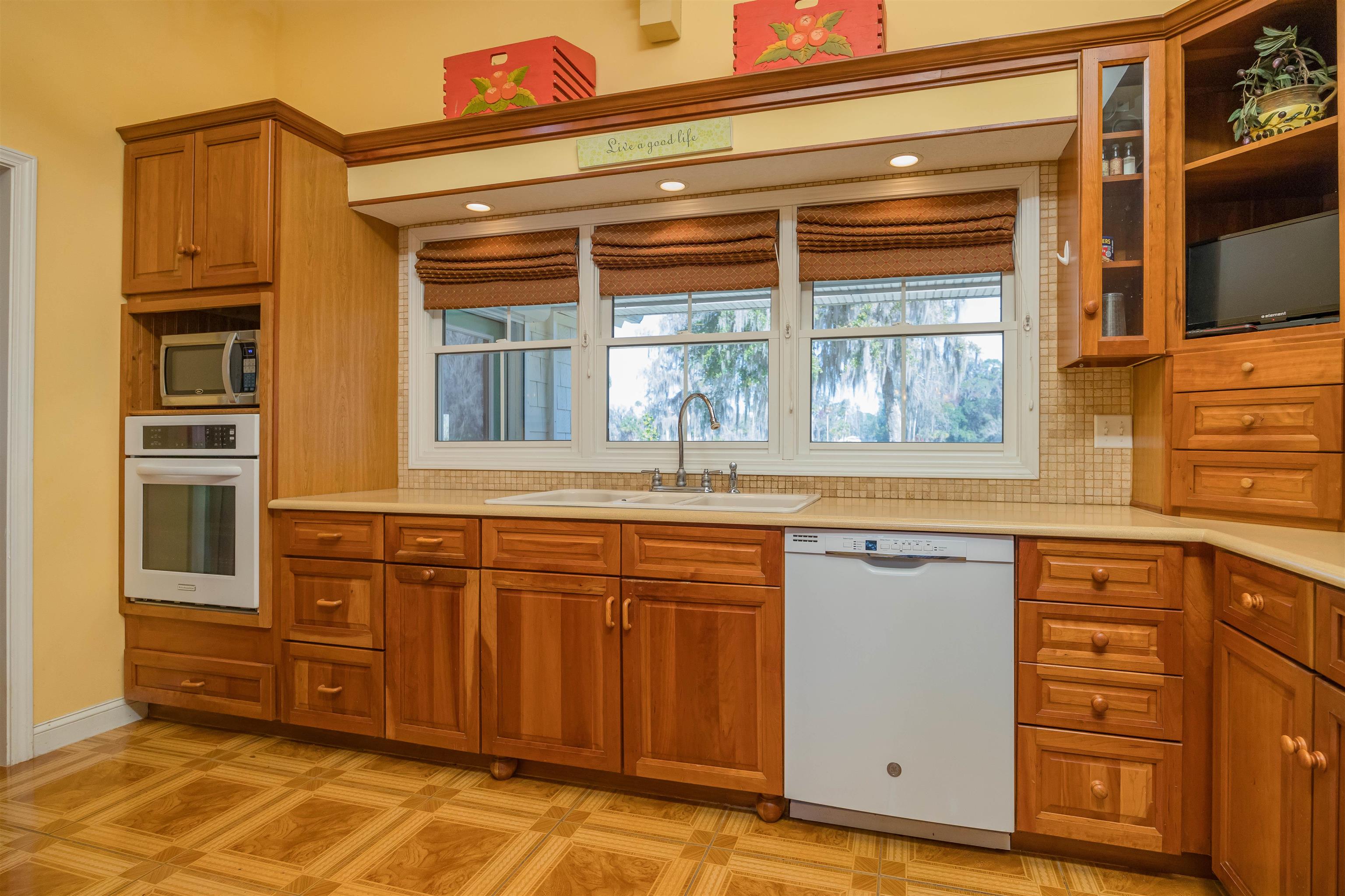 141 Wooten Rd Crescent Crescent City, FL 32112 - Photo 54 of 72 a kitchen with stainless steel appliances granite countertop a stove and a sink