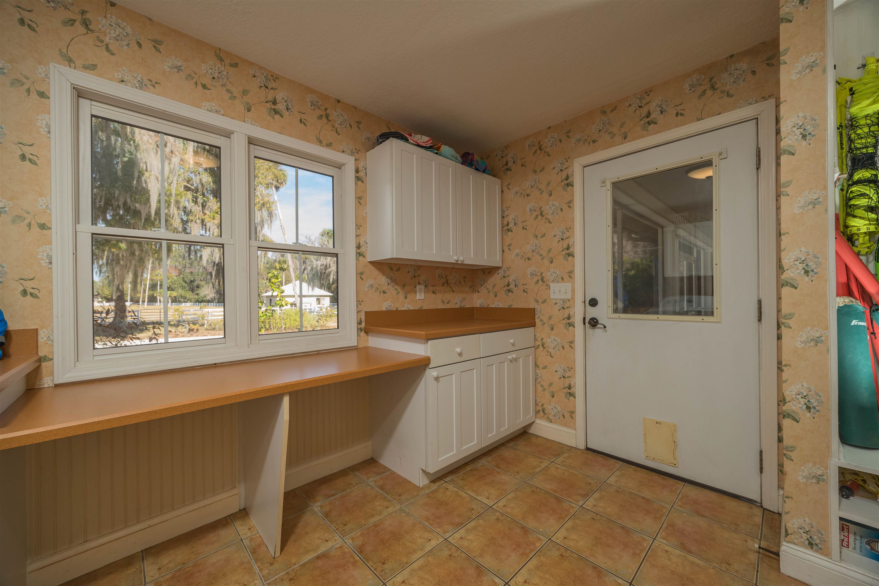 141 Wooten Rd Crescent Crescent City, FL 32112 - Photo 56 of 72 a kitchen with granite countertop white cabinets and a window