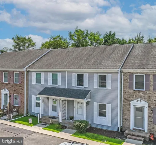 a aerial view of a brick house next to a yard