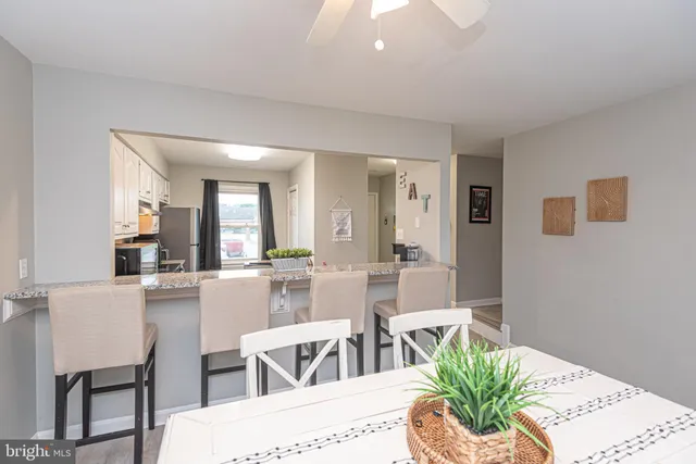 a dining room with furniture and wooden floor
