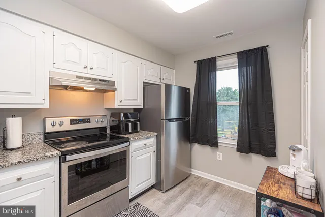 a very nice looking room with a mirror and a window