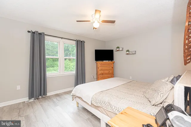 a bedroom with a large bed and a window