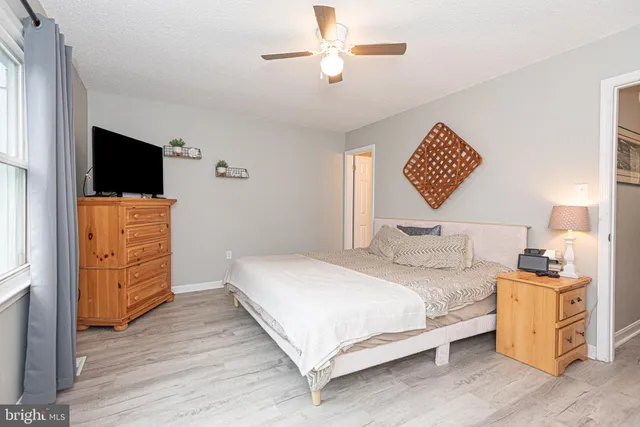 a bathroom with a granite countertop sink a toilet and a shower curtain