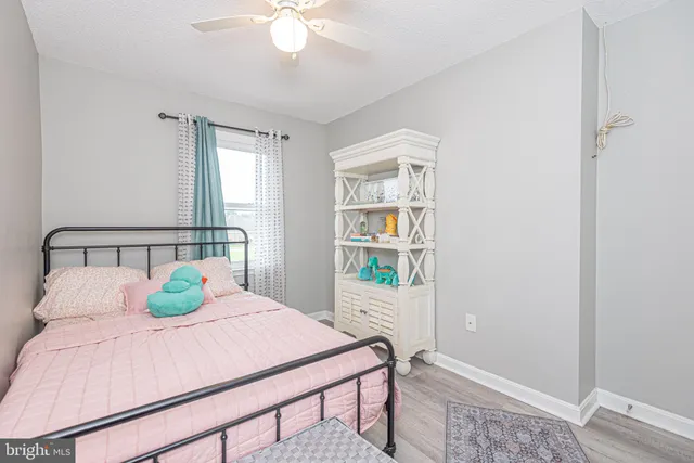a bathroom with a granite countertop sink toilet and mirror