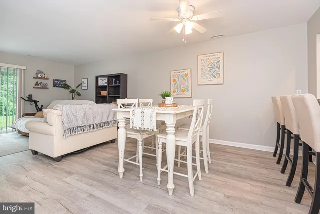 a living room with furniture a flat screen tv and a table
