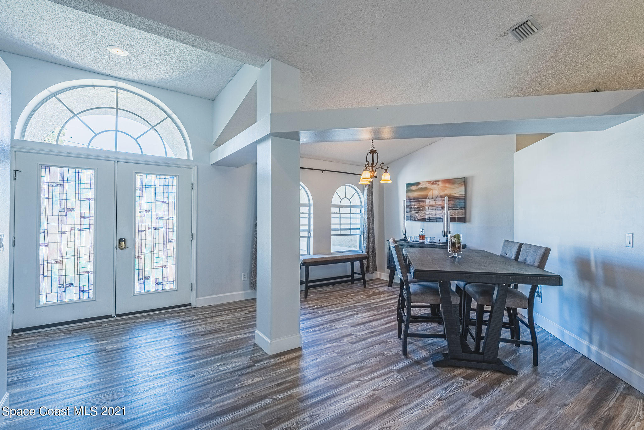 7207 Achilles Road Cocoa, FL 32927 - Photo 11 of 57 a view of a dining room with furniture window and wooden floor