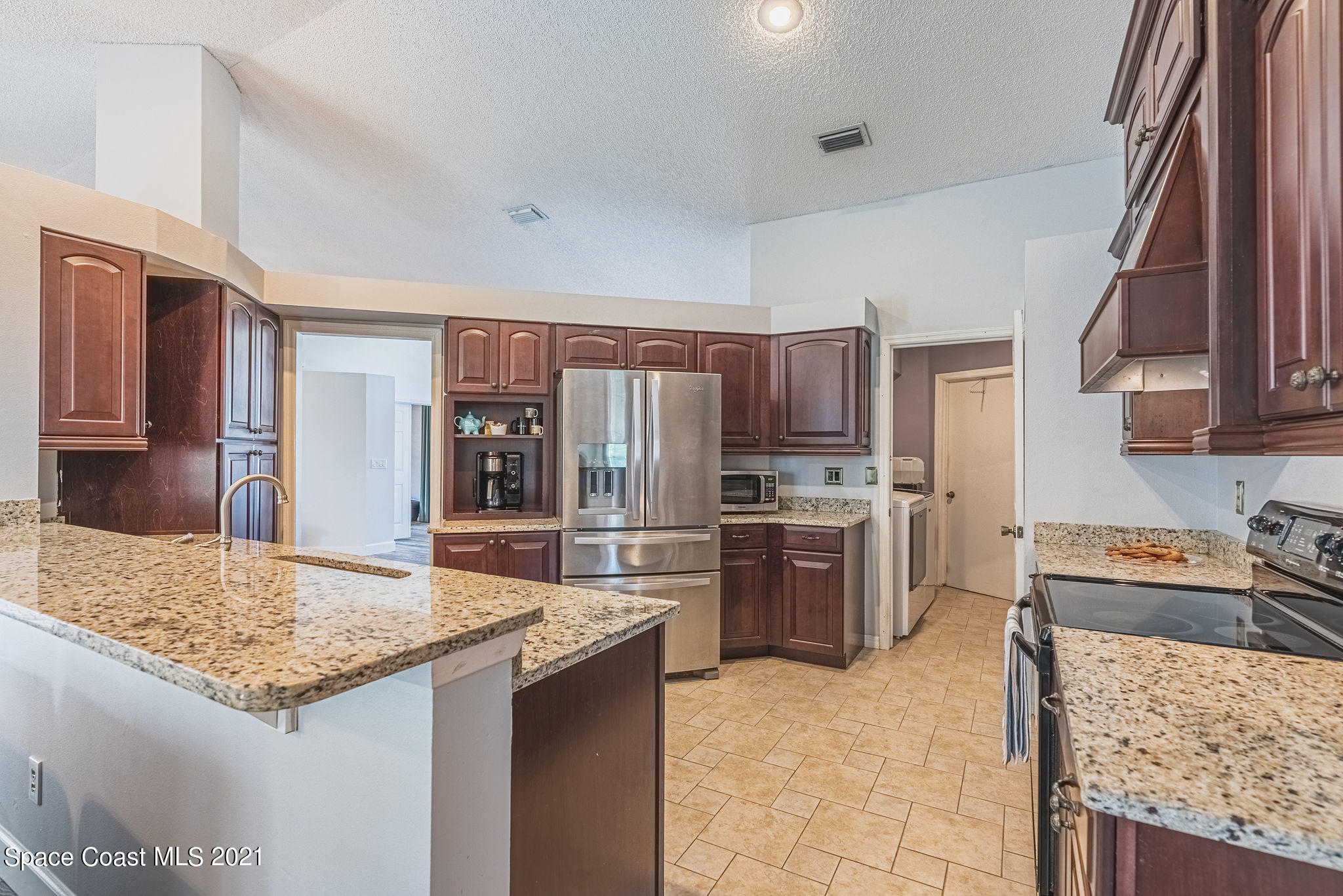 7207 Achilles Road Cocoa, FL 32927 - Photo 13 of 57 a kitchen with refrigerator and stove