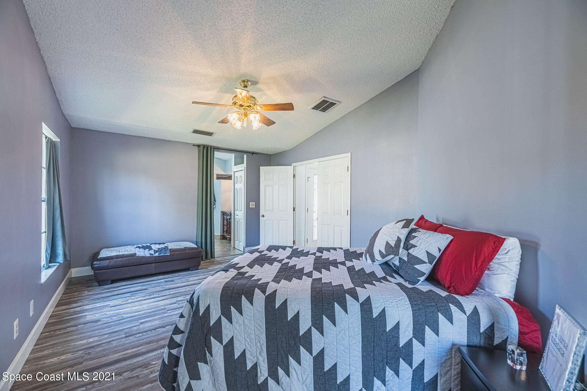 7207 Achilles Road Cocoa, FL 32927 - Photo 23 of 57 a bedroom with a bed and a chandelier