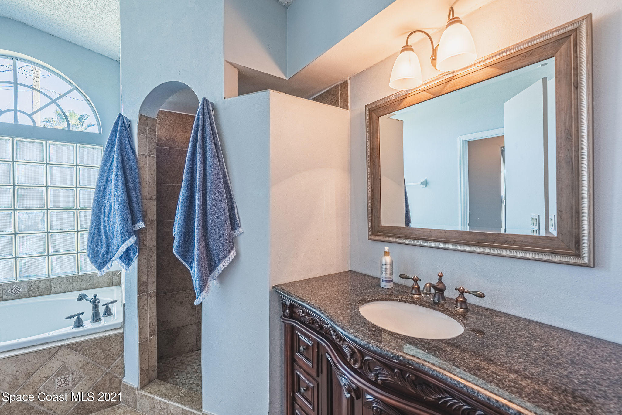 7207 Achilles Road Cocoa, FL 32927 - Photo 25 of 57 a bathroom with a granite countertop sink and a mirror