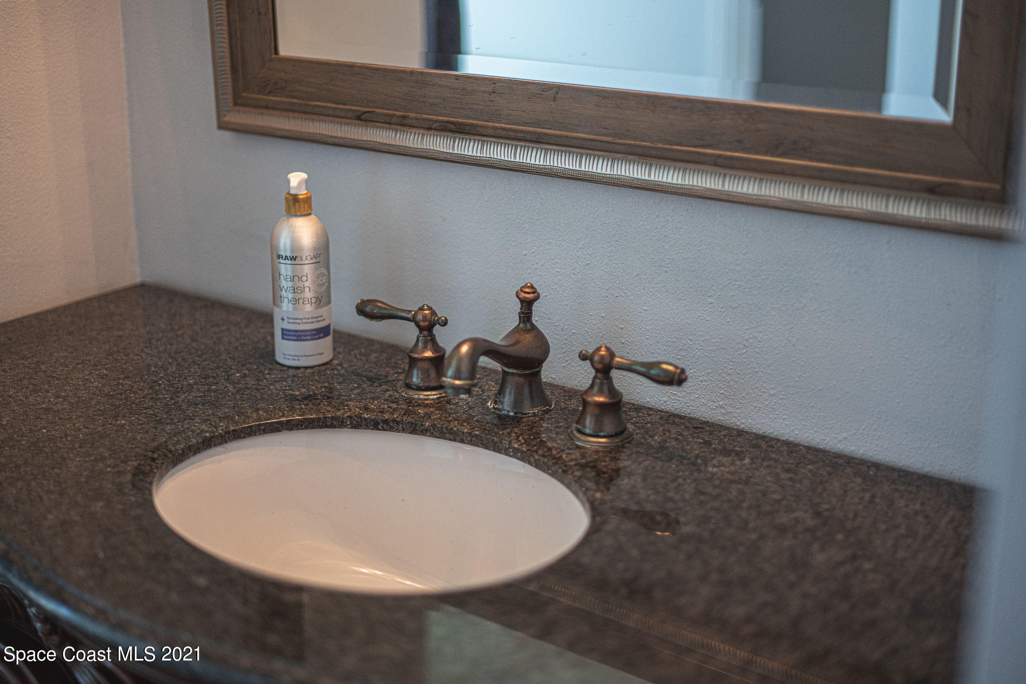 7207 Achilles Road Cocoa, FL 32927 - Photo 26 of 57 a bathroom with a sink and mirror