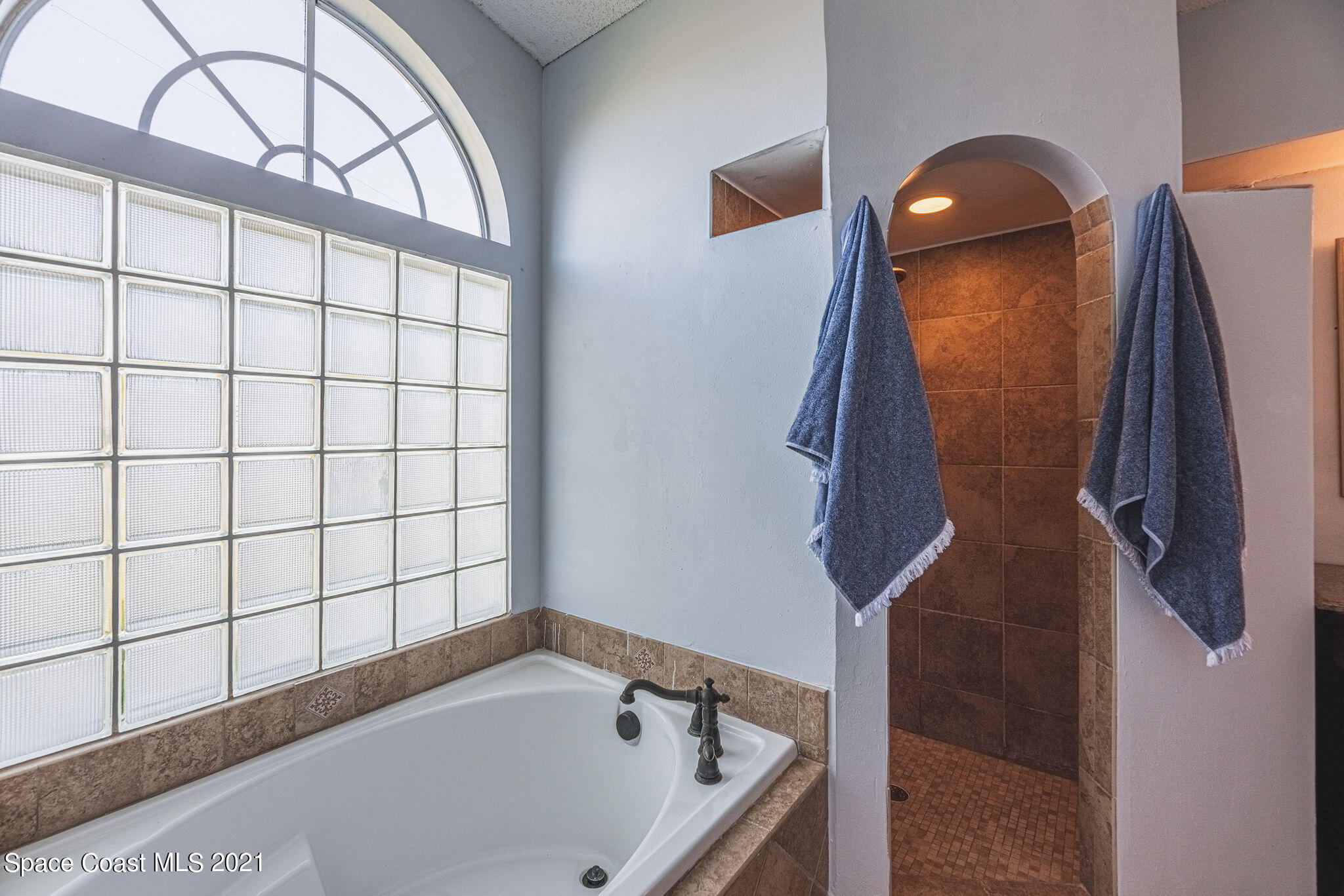 7207 Achilles Road Cocoa, FL 32927 - Photo 29 of 57 a bathroom with a tub and shower