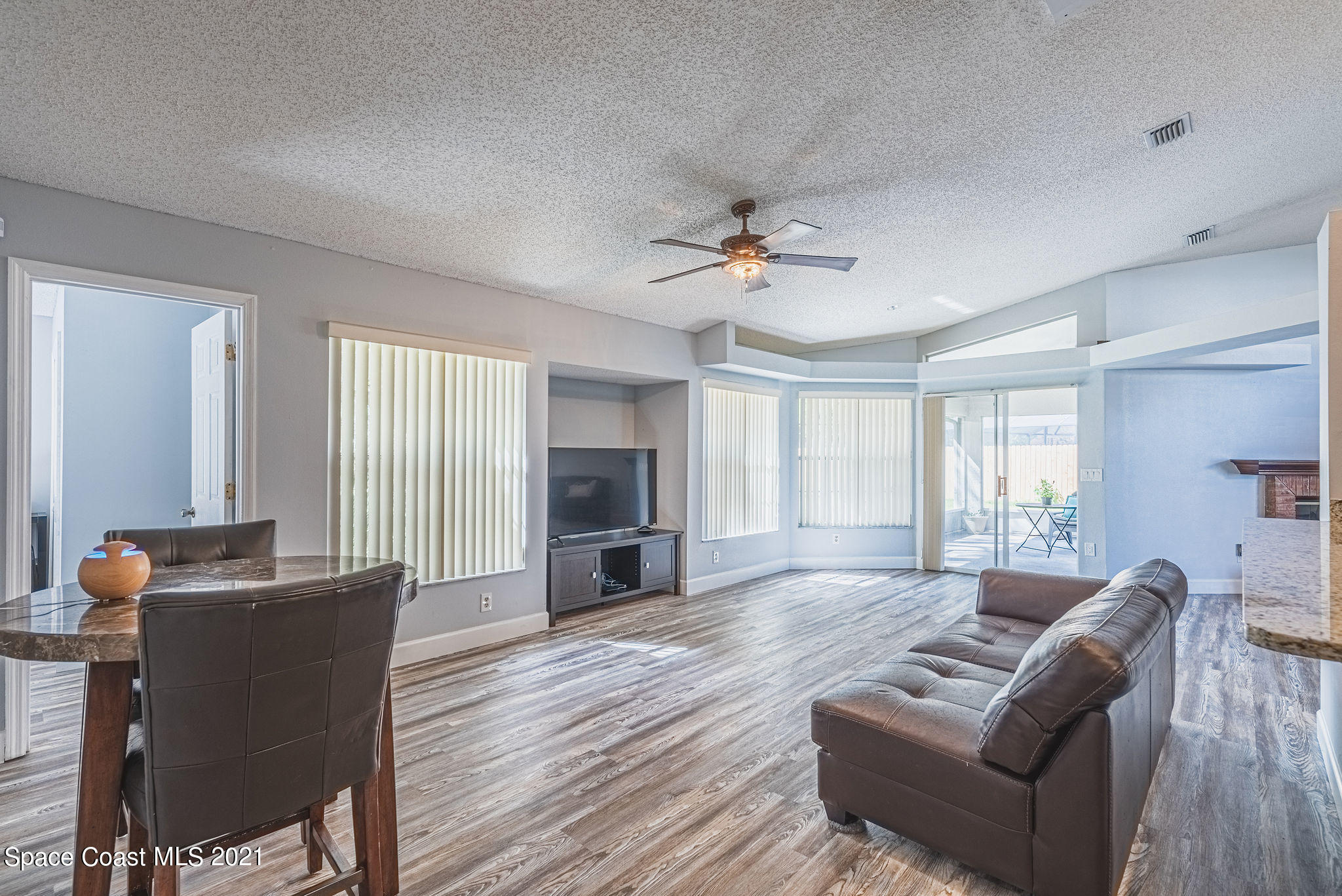 7207 Achilles Road Cocoa, FL 32927 - Photo 32 of 57 a living room with furniture window and wooden floor