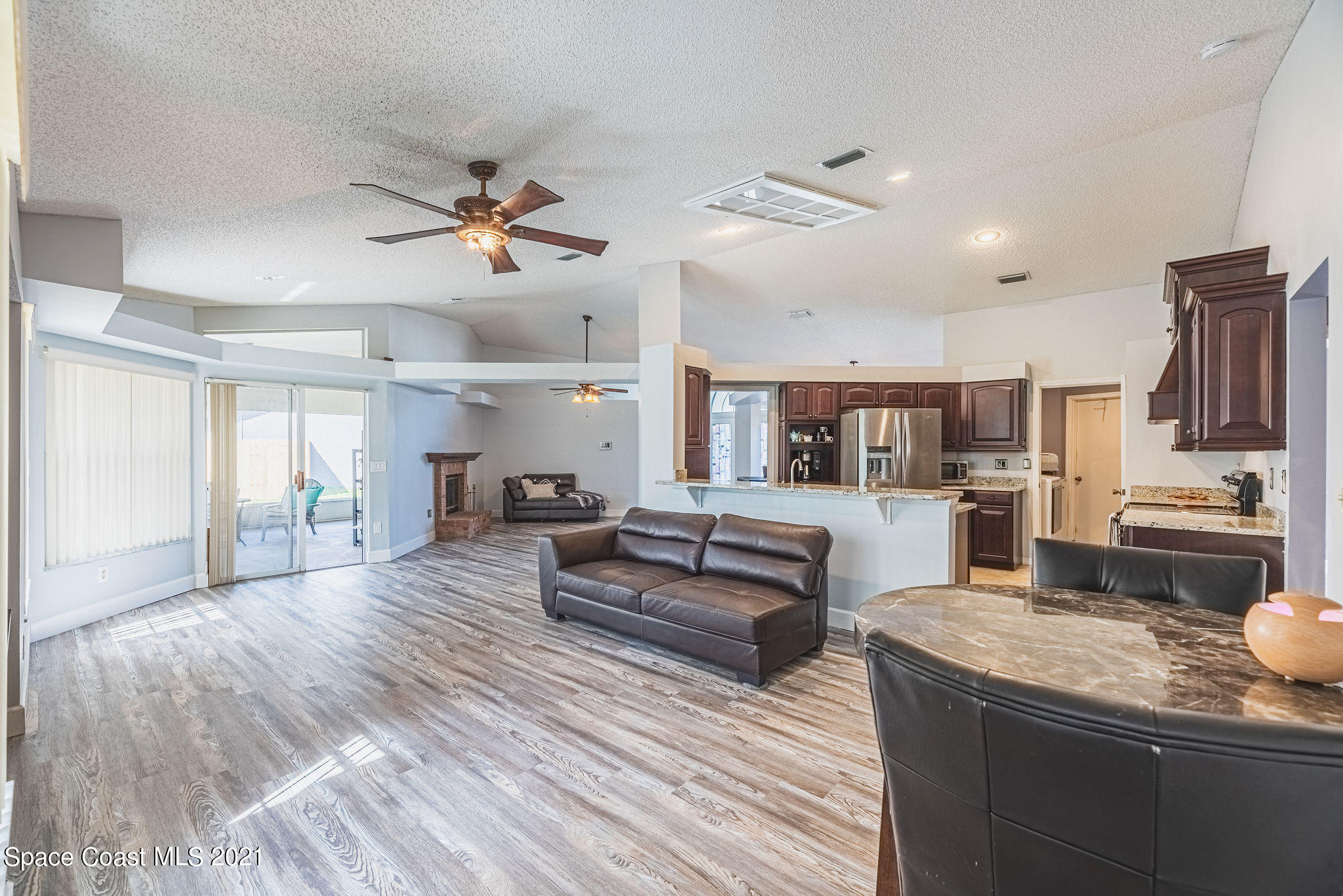 7207 Achilles Road Cocoa, FL 32927 - Photo 34 of 57 a living room with furniture and a wooden floor