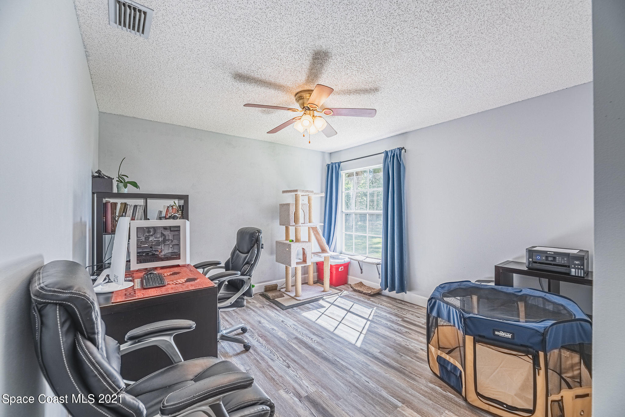 7207 Achilles Road Cocoa, FL 32927 - Photo 38 of 57 a living room with furniture a flat screen tv and a window