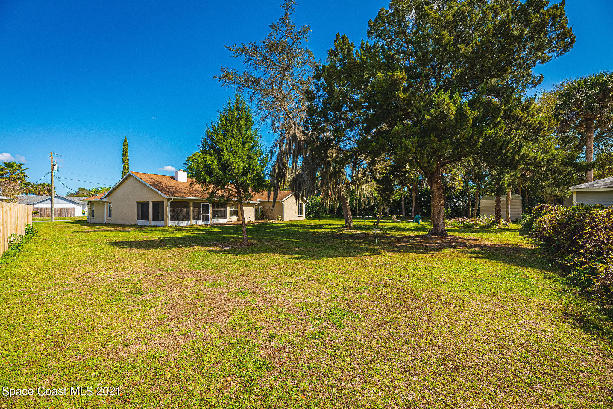 7207 Achilles Road Cocoa, FL 32927 - Photo 46 of 57 a view of swimming pool with lawn chairs and large trees